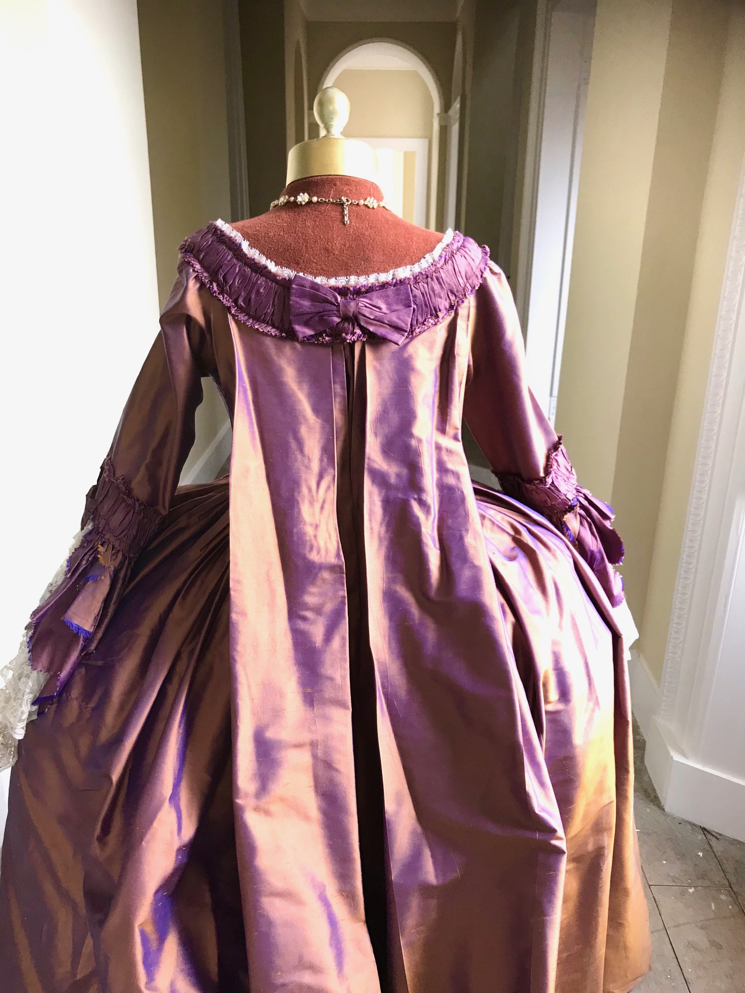 An exceptional lady's 18th century style sack dress, bronze and purple with fine lace cuffs - with skirt and pannier frame. Ex London Festival Opera 'The Magic Flute'.